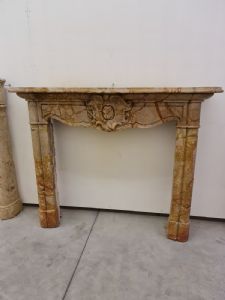 18th-century marble fireplace with coat of arms.